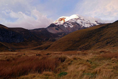 Scenic view of mountains against cloudy sky