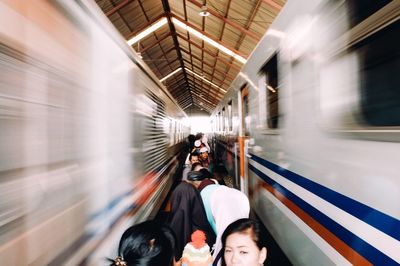 People on train at railroad station platform