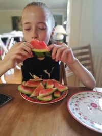 Close-up of boy eating food in plate