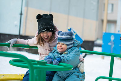 Portrait of cute girl sitting on slide