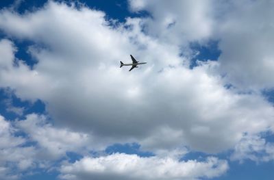 Low angle view of airplane flying in sky