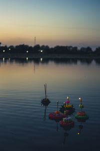 Scenic view of lake against sky during sunset, loy krathong