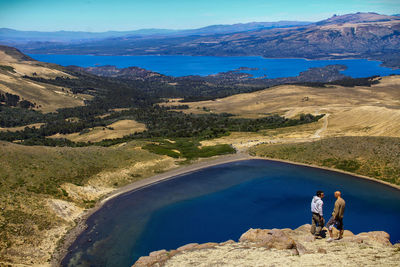 Friends standing on cliff