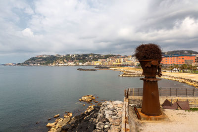 Scenic view of sea and buildings against sky