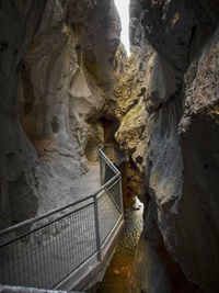 View of narrow stairs along rocks