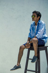 Young man sitting on chair