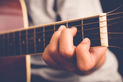 Cropped hand playing guitar