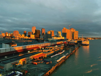 High angle view of river by buildings in city against sky