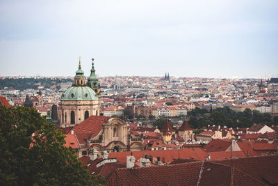 Aerial view of townscape against sky in city