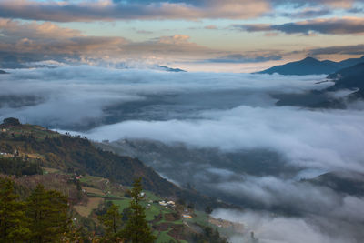 Scenic view of dramatic landscape against sky during sunset