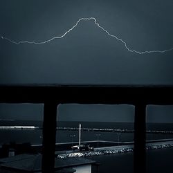 Low angle view of illuminated bridge against sky