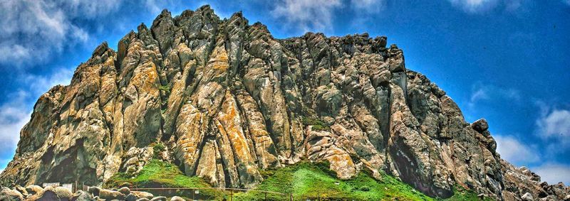 Low angle view of rock formation against sky