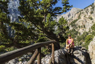 Woman sitting on rock in forest