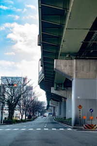 Road by highway against sky