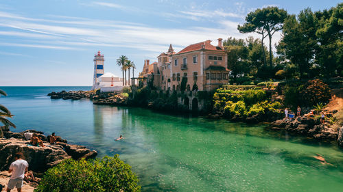 Scenic view of sea and buildings against sky