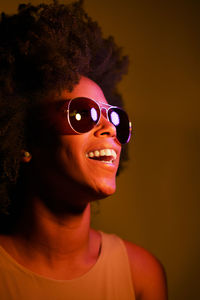 Happy young woman wearing illuminated sunglasses