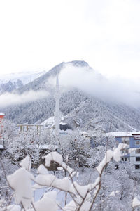 Snow covered landscape against sky