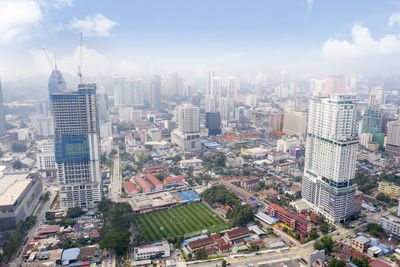 High angle view of buildings in city against sky