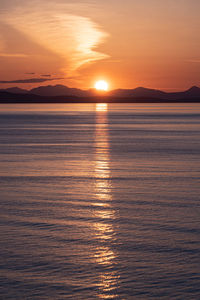 Scenic view of sea against orange sky