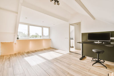 Woman sitting on hardwood floor at home