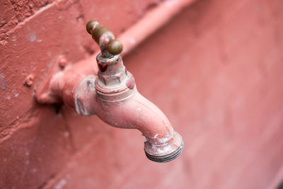 Close-up of faucet mounted on wall