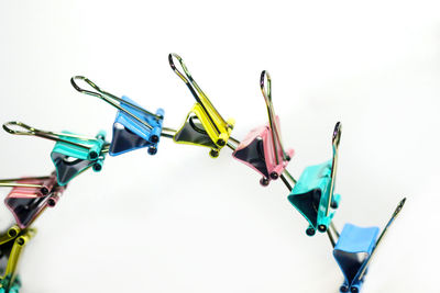 Close-up of multi colored clothespins on white background