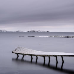 Frozen jetty over water in asa, kungsbacka municipality, halland county, sweden, europe