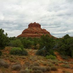 Scenic view of mountains against cloudy sky