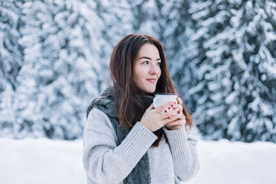 Portrait of young woman using mobile phone