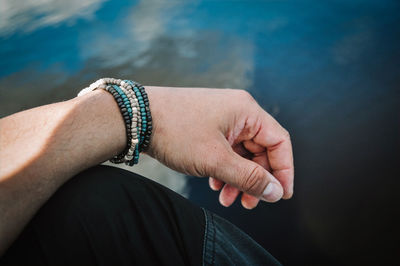 Midsection of woman holding hands in water