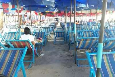 Rear view of woman sitting on chair at cafe