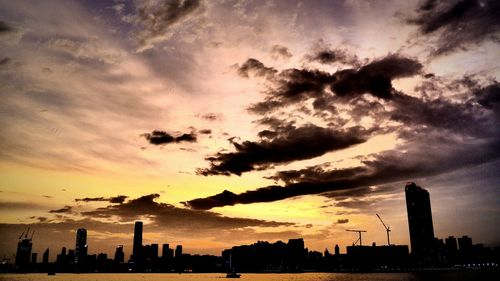 Silhouette of building against dramatic sky