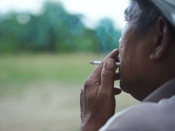 Portrait of man smoking cigarette outdoors