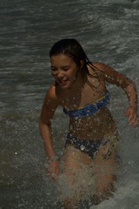 Full length of smiling boy on beach