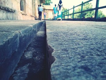 Close-up of people walking on road