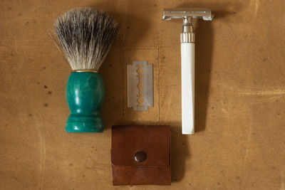 High angle view of shaving equipment on wooden table