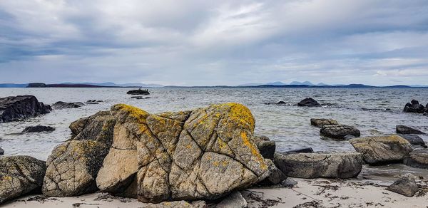 Rocks on beach against sky