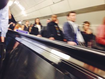 Blurred motion of people standing in bus