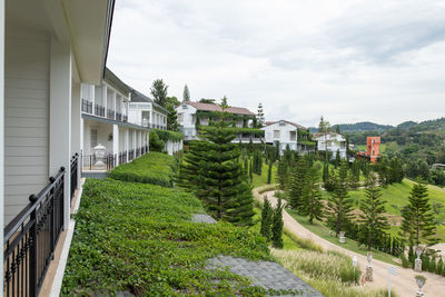 Road amidst buildings against sky