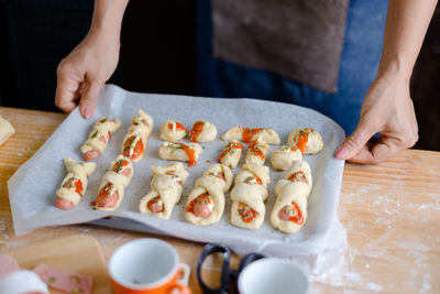 Close-up of woman preparing food on table