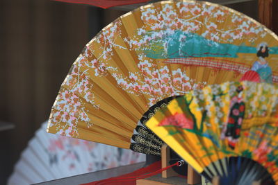 Close-up of patterned hand fans for sale at market