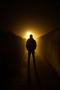 Silhouette of man standing on road