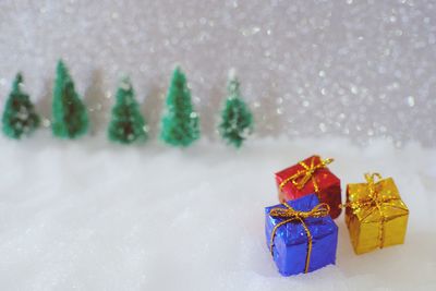 Close-up of small christmas presents on fake snow