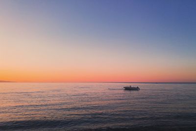 Scenic view of sea against clear sky during sunset