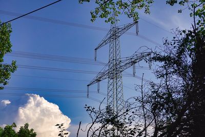 Low angle view of electricity pylon against sky