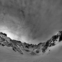 Scenic view of snow covered mountains against sky