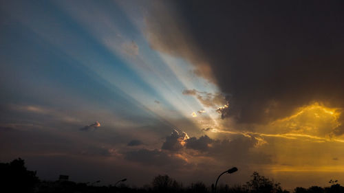 Low angle view of silhouette bird flying against sunset sky