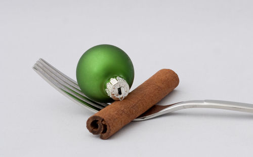 Close-up of bread on table against white background
