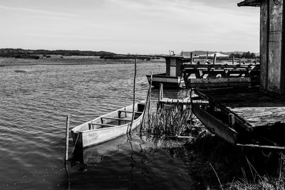 Boats moored in sea against sky