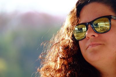 Close-up portrait of woman using smart phone outdoors